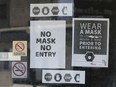 Covid-19 mask advisories are shown on the door of a Windsor, ON. business on Saturday, August 15, 2020.