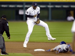 Second baseman Niko Goodrum of the Detroit Tigers can't catch the pickoff throw as Whit Merrifield of the Kansas City Royals steals second base during the sixth inning at Comerica Park on September 16, 2020, in Detroit, Michigan.