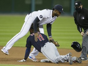 Niko Goodrum #28 of the Detroit Tigers falls over Jose Ramirez #11 of the Cleveland Indians, who stretched a hit into a double, during the seventh inning at Comerica Park on September 17, 2020, in Detroit, Michigan.