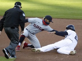 Shortstop Francisco Lindor of the Cleveland Indians tags out Victor Reyes of the Detroit Tigers trying to steal second base with umpire Tim Timmons covering the bag during the first inning at Comerica Park on September 19, 2020, in Detroit, Michigan.