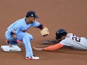 Victor Reyes #22 of the Detroit Tigers steals second base against Jorge Polanco #11 of the Minnesota Twins during the first inning of the game at Target Field on September 23, 2020 in Minneapolis, Minnesota.