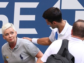 Novak Djokovic of Serbia tends to a line judge who was hit with the ball during his Men's Singles fourth round match against Pablo Carreno Busta of Spain on Day Seven of the 2020 US Open at the USTA Billie Jean King National Tennis Center on Sept. 6, 2020, in the Queens borough of New York City.