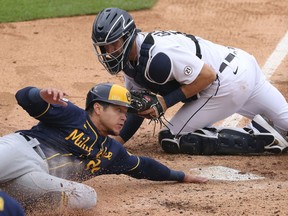 Avisail Garcia #24 of the Milwaukee Brewers slides into home plate score a run in the fourth inning past Grayson Greiner #17 of the Detroit Tigers at Comerica Park on Sept. 9, 2020 in Detroit, Michigan.