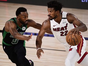 Jimmy Butler, right, of the Miami Heat drives the ball against Kemba Walker of the Boston Celtics during the fourth quarter in Game 1 of the Eastern Conference Finals during the 2020 NBA Playoffs at The Field House at the ESPN Wide World Of Sports Complex on Sept. 15, 2020 in Lake Buena Vista, Florida.