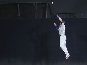 A.J. Pollock of the Los Angeles Dodgers leaps to catch a fly ball hit by Fernando Tatis Jr. of the San Diego Padres during the third inning of a game at PETCO Park on September 15, 2020 in San Diego, California.