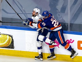 Barclay Goodrow of the Tampa Bay Lightning is checked into the boards by Brock Nelson of the New York Islanders during the second period in Game Six of the Eastern Conference Final during the 2020 NHL Stanley Cup Playoffs at Rogers Place on Sept. 17, 2020 in Edmonton.