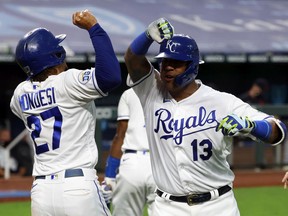 Salvador Perez of the Kansas City Royals is congratulated by Adalberto Mondesi after hitting a three-run home run during the 1st inning of the game against the Detroit Tigers at Kauffman Stadium on September 24, 2020 in Kansas City, Missouri.