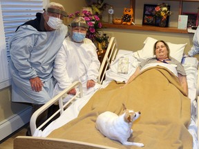 Hospice resident Diane Costello is visited by her parents Norman and Marolyn Hotchkiss, left, of Michigan and her pet dog Shamrock at The Hospice Village on Sept. 18, 2020.