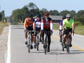 Cyclist Michael Groh, centre, leads a group of riders on Baseline Road nearing the end of their morning ride from Leamington Saturday morning. Groh is happy to be back riding after suffering a near-fatal collapse while riding last year.
