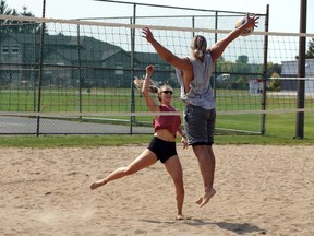 LaSalle, Ontario. September 24, 2020. Katherine Roberge, left, spikes the volleyball against Ian Griffin during a one-on-one beach volleyball game at Gil Maure Park Thursday.  A small group of six volleyball players enjoyed a beautiful autumn afternoon, getting some sunshine and physical activity. (NICK BRANCACCIO/Windsor Star)