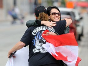 Freedom Day Rally attendees hug as they arrive at Charles Clark Square for a public gathering in downtown Windsor on Saturday, Sept. 5, 2020, hosted by the Hugs Over Masks group.