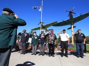 Korean War veteran Pete Remdenok, left, salutes during the playing of O Canada at the Battle of Britain memorial service at Jackson Park Sunday, Sept. 20, 2020.  Joining Remdenok and standing in front of wreaths were Ron Sitarz, RCNA, Bob Goyeau, Korean Veterans Assoc., Bud Kosikowsky, Can. Historical Air Craft Assoc., Scott Davidson, North Wall Riders, Paul Lauzon, Windsor Veterans Memorial Service Committee and Geoff Bottoms, right, Southern Ontario Military Muster.