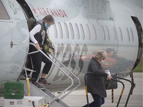 Passengers disembark from an Air Canada flight from Toronto, at Windsor International Airport, Wednesday, September 9, 2020.