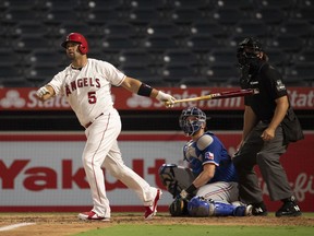 Los Angeles Angels designated hitter Albert Pujols hits a home run against the Texas Rangers during the game at Angel Stadium.