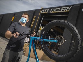 Last one standing. Sam Miller, head mechanic at City Cyclery, is shown Wednesday, Sept. 2, 2020, with his Windsor shop's only bike left in stock this week after COVID-19 sparked a huge demand for cycling.