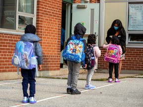 FILE PHOTO: Students arrive for the first time since the start of the coronavirus disease (COVID-19) pandemic at Hunter's Glen Junior Public School, part of the Toronto District School Board (TDSB) in Scarborough, Ontario, Canada September 15, 2020.