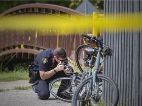 OPP officers investigate a collision between two cyclists on a bike trail adjacent to Ross Beach Road in Lakeshore that sent one person to hospital with life threatening injuries, Tuesday, September 1, 2020.