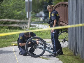 OPP officers investigate a collision between two cyclists on a bike trail adjacent to Ross Beach Road in Lakeshore that sent one person to hospital with life threatening injuries, Tuesday, September 1, 2020.