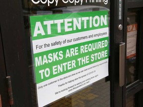 A sign posted at a downtown business in Sudbury, Ont. requires customers to wear face masks when entering the store.
