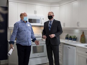 Homeowner, Nick Bibic, who took advantage of the Enbridge Gas Home Efficiency Retrofit Program, gives a tour of his home to Mayor Drew Dilkens, during a press event, Thursday, September 24, 2020.