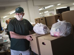 Roger Dionne distributes food packages to clients at the Windsor Goodfellows, Tuesday, September 22, 2020.