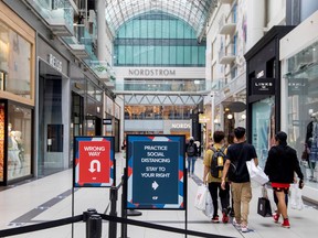 FILE PHOTO: People walk in the Eaton Centre shopping mall, as the provincial phase 2 of reopening from the coronavirus disease (COVID-19) restrictions begins in Toronto, Ontario, Canada June 24, 2020.