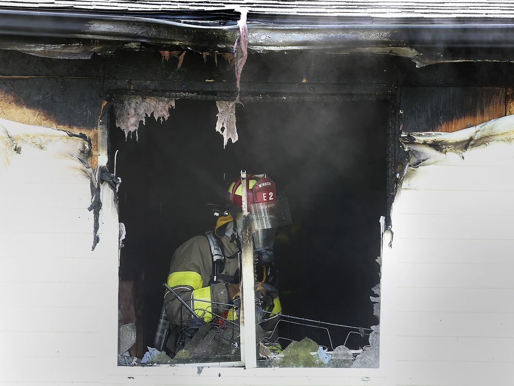 A Windsor firefighter is shown at the scene of a house fire on Tuesday, September 15, 2020 in the 1200 block of Hickory Rd. Four adults and two children were displaced and a neighbour who tried to extinguish the fire was treated for minor smoke inhalation.
