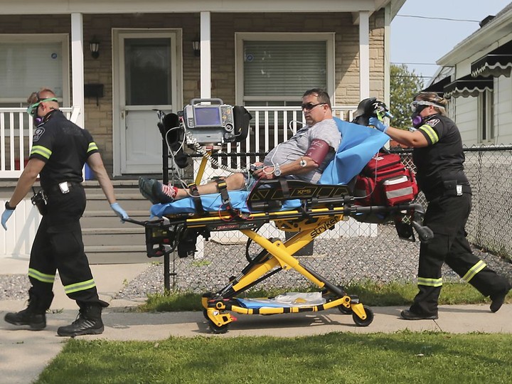  Paramedics transport a man at the scene of a house fire on Tuesday, September 15, 2020 in the 1200 block of Hickory Rd. Four adults and two children were displaced and a neighbour who tried to extinguish the fire was treated for minor smoke inhalation.