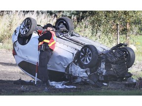 A LaSalle police officer is shown at the scene of a single vehicle rollover on Tuesday, September 29, 2020, near the intersection of Front Rd. and Malden Rd. The early morning accident resulted in the lone motorist being taken to hospital with serious injuries.