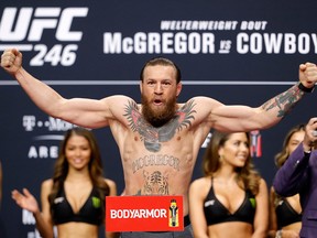 In this Jan. 17, 2020, file photo, welterweight fighter Conor McGregor poses on the scale during a ceremonial weigh-in for UFC 246 at Park Theater at Park MGM in Las Vegas.