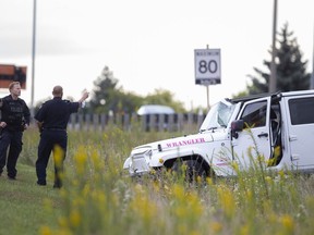 Emergency crews work at the scene of a two-vehicle collision between a Jeep and a transport truck that caused the Jeep to roll over into the centre median of E.C. Row Expressway at Huron Church Road, Wednesday, September 30, 2020.