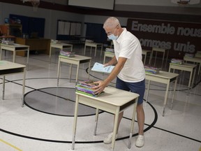 Michael Cusinato, principal at St. Anne French Immersion Catholic Elementary School, prepares for the start of the school year in the school's gymnasium, Wednesday, September 9, 2020.  The gymnasium will hold Amy de Cecco's Grade 8 class.