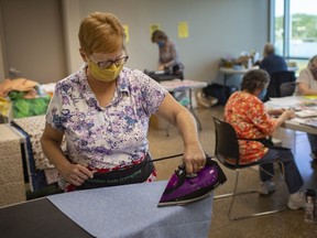 Volunteers with the Windsor Essex Sewing Force, prepare mask kits for sewing, at the WFCU Centre, Monday, September 21, 2020.  The group reached 25,000 masks and caps produced for the Windsor-Essex community.