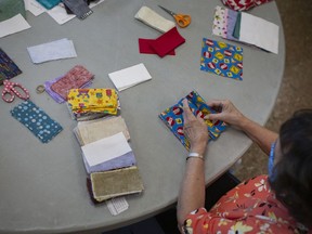Volunteers with the Windsor Essex Sewing Force, prepare mask kits for sewing, at the WFCU Centre, Sept. 21, 2020. The group had reached 25,000 masks and caps produced for the Windsor-Essex community.