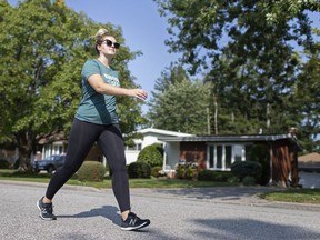 Jory Fulcher, a masters student in human kinetics at the University of Windsor, walks down her street in South Windsor, Thursday, September 25, 2020.  Fulcher uses a Fitbit to track her walking for a University of Windsor study on walking during the pandemic.