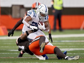 Jonathan Taylor of the Indianapolis Colts runs with the ball while being tackled by Sione Takitaki of the Cleveland Browns in the first quarter at FirstEnergy Stadium on October 11, 2020 in Cleveland, Ohio.