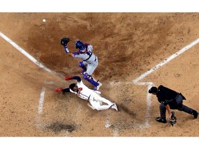 Ozzie Albies of the Atlanta Braves comes home to score a run against the Los Angeles Dodgers during the sixth inning in Game Four of the National League Championship Series at Globe Life Field on October 15, 2020 in Arlington, Texas.