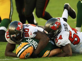 Jason Pierre-Paul and Lavonte David of the Tampa Bay Buccaneers sack Aaron Rodgers of the Green Bay Packers during the third quarter at Raymond James Stadium on October 18, 2020.