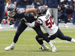 Tyrell Adams of the Houston Texans tackles Geoff Swaim of the Tennessee Titans in the second half of their game at Nissan Stadium on October 18, 2020 in Nashville, Tennessee. The Titans defeated the Texans 42-36 in overtime.