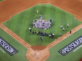 The Los Angeles Dodgers pose for a photo following their 4-3 victory against the Atlanta Braves in Game Seven of the National League Championship Series at Globe Life Field on October 18, 2020 in Arlington, Texas.