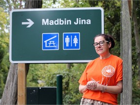 Carrie Ann Peters, cultural development coordinator with Caldwell First Nations, at the new Madbin Jina sign at a re-named spot in Point Pelee National Park on Friday, Oct. 2, 2020. The new name, Madbin Jina, invites visitors to come and 'sit a while'.