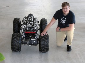 Optimotive Technologies founder Scott Fairley with an autonomous search and rescue vehicle. The vehicle weighs 300 lbs. and is called Iris.