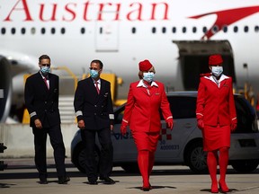 Flight crew members of Lufthansa's unit Austrian Airlines are pictured ahead of takeoff to New York at the Vienna International Airport in Schwechat, Austria July 1, 2020.