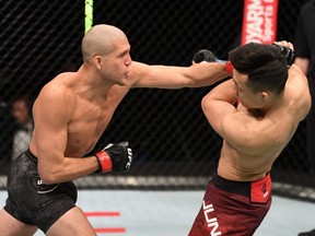 In this handout image provided by UFC, Brian Ortega, left, punches The Korean Zombie Chan Sung Jung in their featherweight bout during the UFC Fight Night event inside Flash Forum on UFC Fight Island in Abu Dhabi, United Arab Emirates, Sunday, Oct. 18, 2020.