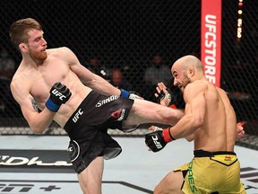In this handout image provided by UFC, Cory Sandhagen kicks Marlon Moraes in their bantamweight bout during the UFC Fight Night event October 11, 2020 in Yas Island, Abu Dhabi.