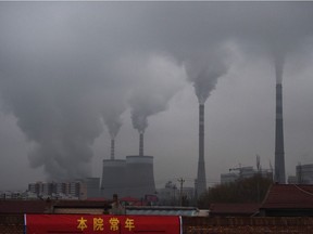 This file photo taken on November 19, 2015 shows smoke belching from a coal-fueled power station near Datong, in China's northern Shanxi province. China's surprise pledge to slash its carbon footprint to zero by 2060 was met with cautious applause, but fresh spending on coal to rev up a virus-hit economy threatens to nullify its audacious bid to lead the world into a low carbon future.