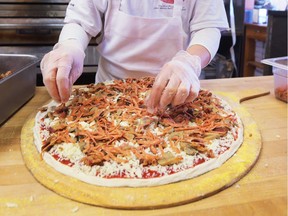 An employee at Antonino's Original Pizza Inc. at the South Windsor location in shown making a pie in this Dec. 27, 2017, file photo. Antonino's in Windsor, LaSalle and Tecumseh among more than a dozen pizzerias participating in the Oct. 20 Pizza for Polio fundraiser.