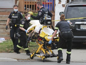 Paramedics transport a man who was the victim of a violent assault on Thursday, October 29, 2020, in front of a home in the 1300 block of Pierre Ave. in Windsor.