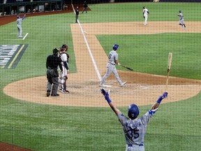 Los Angeles Dodgers catcher Will Smith hits a three run home run during the sixth inning against the Atlanta Braves during game five of the 2020 NLCS at Globe Life Field.