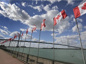 Ottawa has eased up border restrictions to allow more people to cross the border during the COVID-19 health emergency. Shown here on Oct. 8, 2020, with the Ambassador Bridge in the background, are Windsor's riverfront Flags of Remembrance.